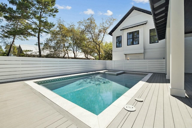 view of swimming pool with a deck, a fenced backyard, an in ground hot tub, and a fenced in pool