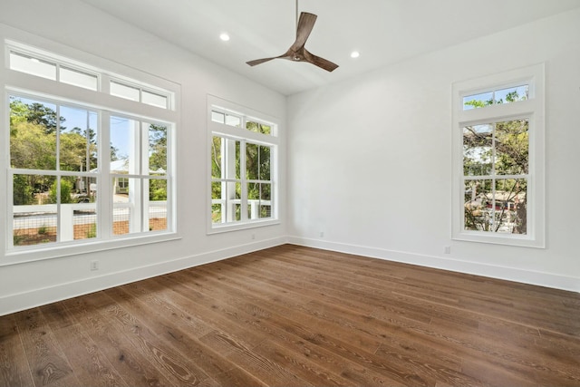 empty room with recessed lighting, a ceiling fan, baseboards, and dark wood-type flooring
