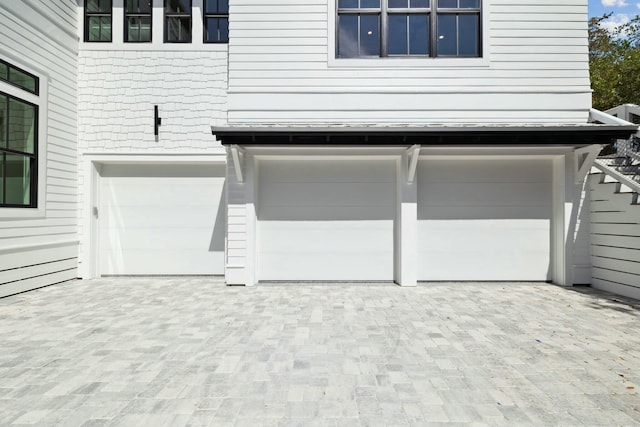 garage featuring decorative driveway