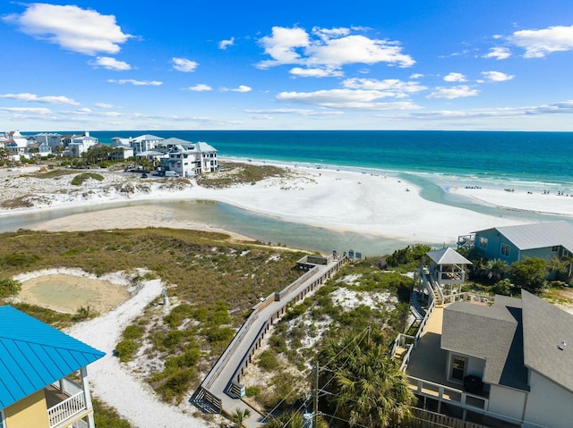 birds eye view of property with a beach view and a water view