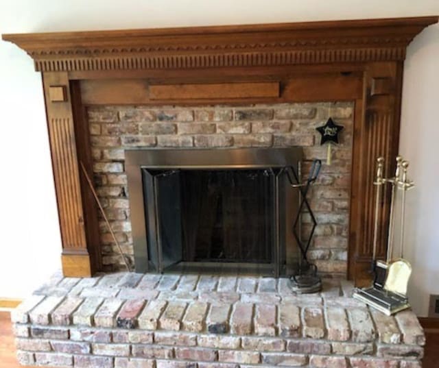 room details featuring visible vents and a fireplace with raised hearth