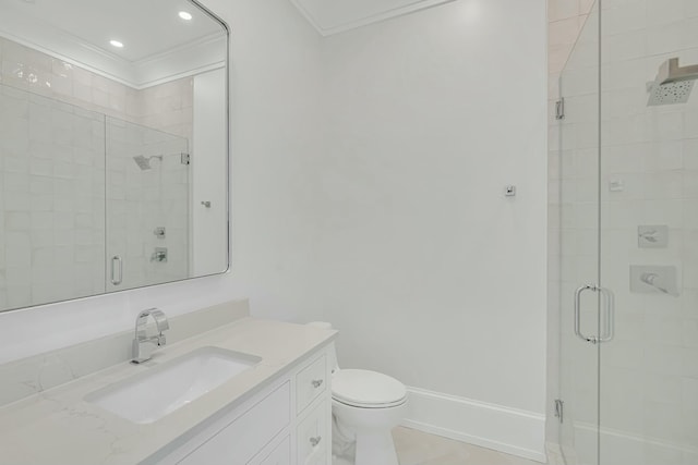 bathroom featuring vanity, crown molding, a stall shower, toilet, and baseboards