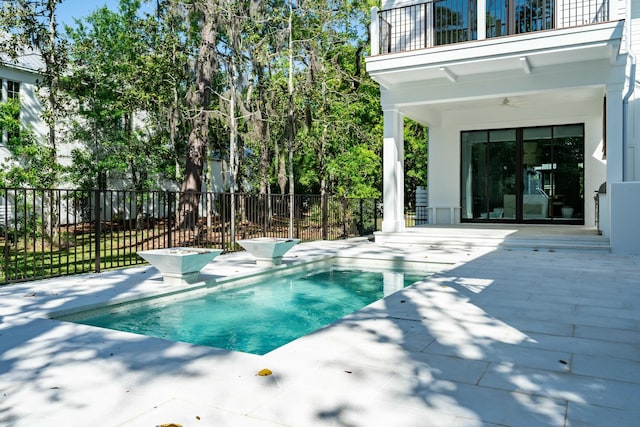 view of pool with fence, a fenced in pool, and a patio area