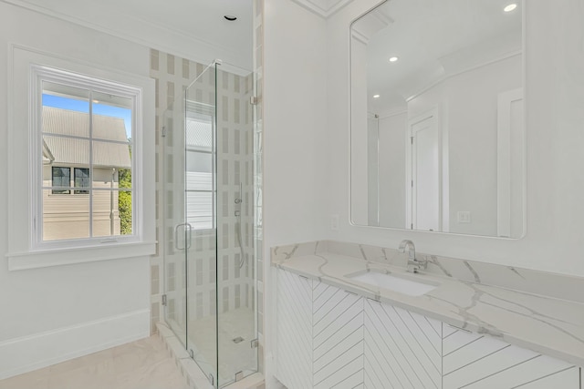 bathroom with recessed lighting, a shower stall, vanity, baseboards, and crown molding