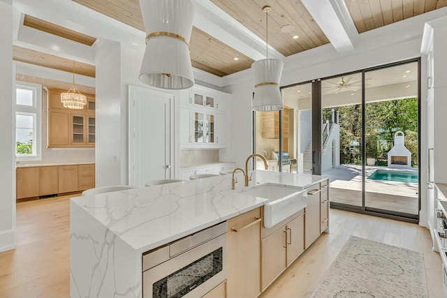 kitchen with a wealth of natural light, wood ceiling, appliances with stainless steel finishes, and a sink