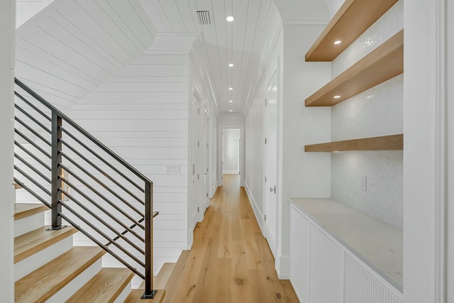 corridor featuring visible vents, recessed lighting, ornamental molding, and light wood-style floors