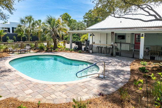view of swimming pool featuring fence, a fenced in pool, and a patio area