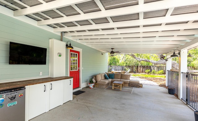 view of patio with fence and ceiling fan