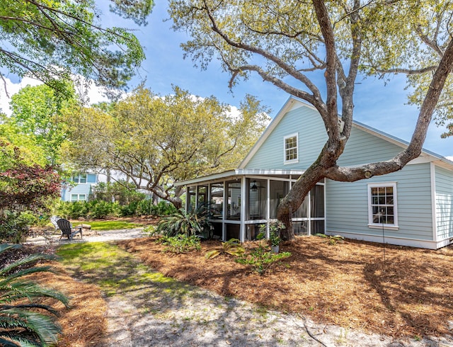 rear view of house featuring a sunroom