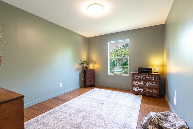 bedroom featuring wood finished floors and baseboards