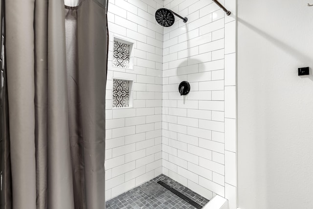 bathroom with tiled shower