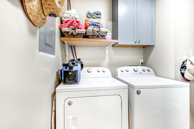 washroom with cabinet space and washing machine and clothes dryer