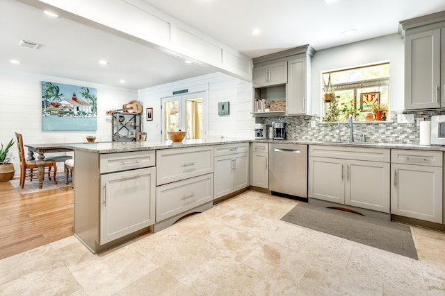 kitchen featuring backsplash, dishwasher, gray cabinetry, visible vents, and a peninsula