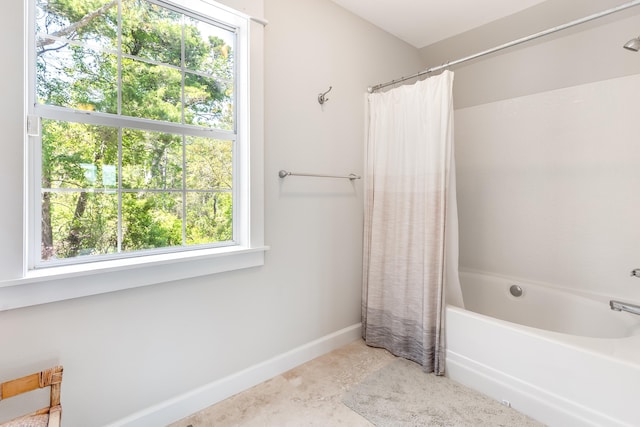 full bathroom with shower / tub combo with curtain and baseboards