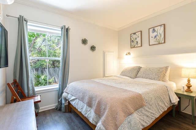 bedroom with baseboards, wood finished floors, multiple windows, and crown molding