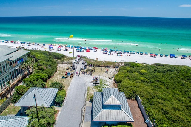 drone / aerial view featuring a beach view and a water view