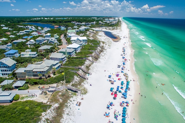 drone / aerial view with a beach view and a water view