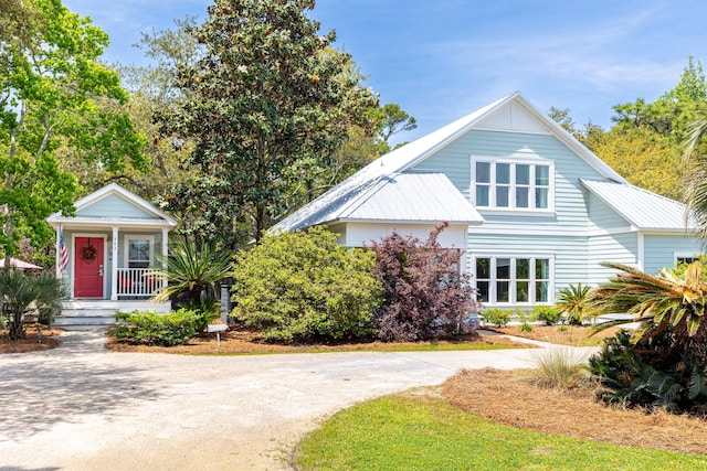 bungalow featuring covered porch and metal roof