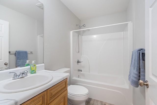 bathroom with toilet, shower / washtub combination, wood finished floors, and vanity