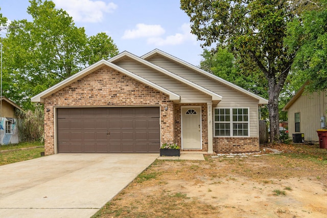 ranch-style home with a garage, central air condition unit, driveway, and brick siding