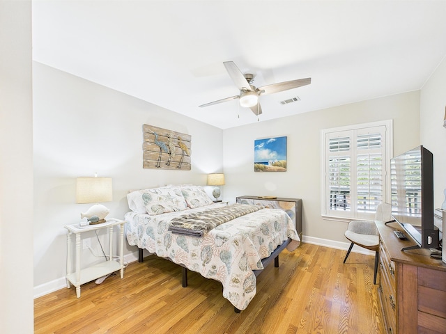 210 Southlake Ct Unit 210, Niceville, FL 32578 - bedroom with wood finished floors, baseboards, a ceiling fan, and a desk