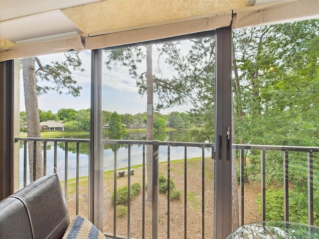 210 Southlake Ct Unit 210, Niceville, FL 32578 - sunroom featuring a water view and view of wooded area