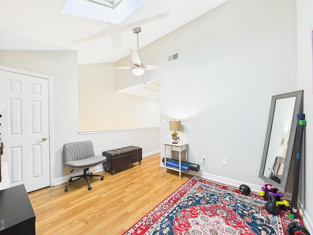 210 Southlake Ct Unit 210, Niceville, FL 32578 - living area featuring a skylight, wood finished floors, a ceiling fan, lofted ceiling, and baseboards