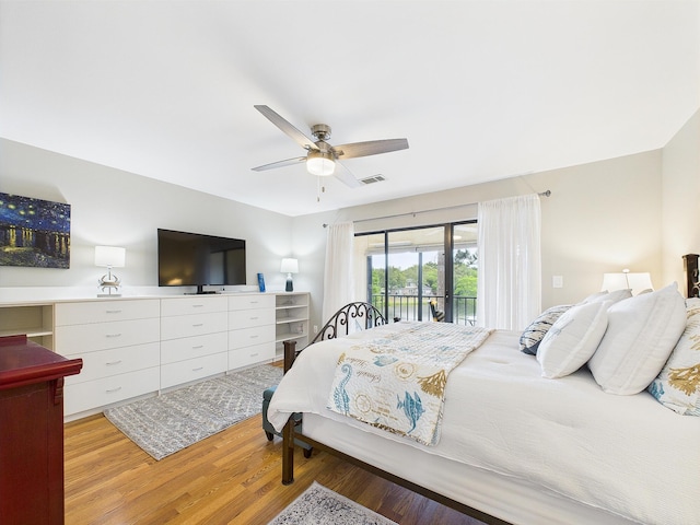 210 Southlake Ct Unit 210, Niceville, FL 32578 - bedroom with access to exterior, light wood-style flooring, and a ceiling fan
