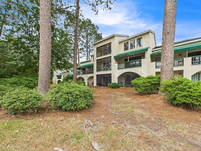 210 Southlake Ct Unit 210, Niceville, FL 32578 - rear view of house with stucco siding