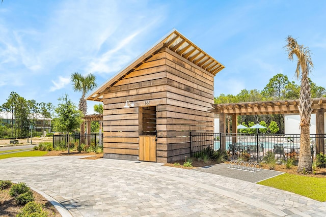 LOT39 String Lily Cv, Santa Rosa Beach, FL 32459 - view of outdoor structure featuring a pergola and a community pool