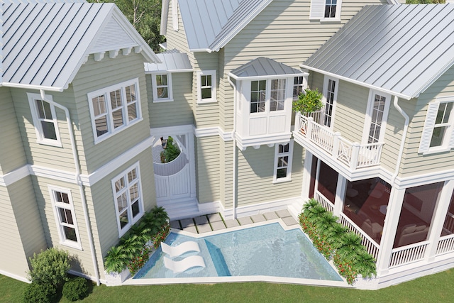 LOT39 String Lily Cv, Santa Rosa Beach, FL 32459 - back of house featuring a standing seam roof, metal roof, and an outdoor pool