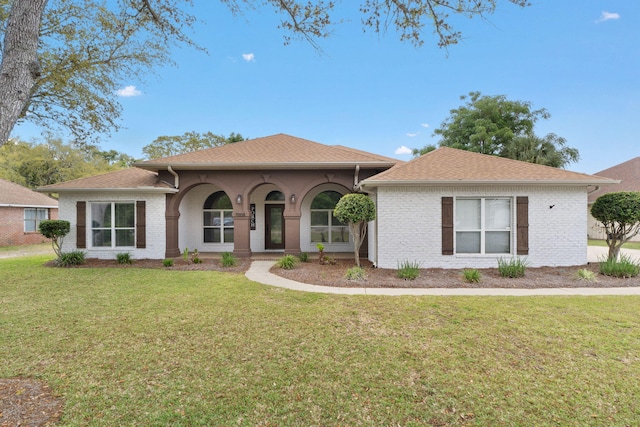 7008 Turnberry Cir, Navarre, FL 32566 - view of front of home featuring brick siding, a shingled roof, and a front lawn