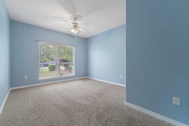 7008 Turnberry Cir, Navarre, FL 32566 - spare room featuring a ceiling fan, carpet, and baseboards
