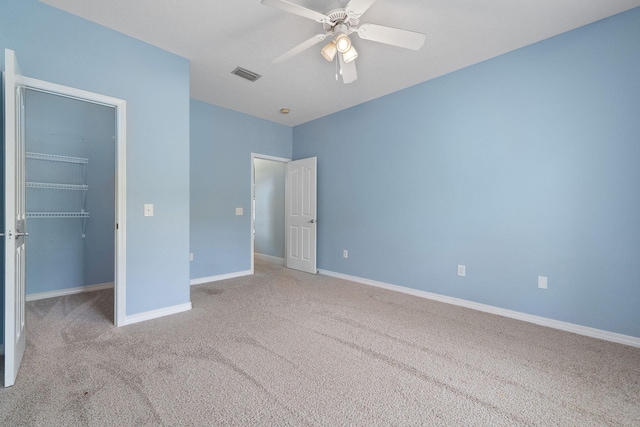 7008 Turnberry Cir, Navarre, FL 32566 - unfurnished bedroom with visible vents, a closet, baseboards, carpet floors, and a spacious closet