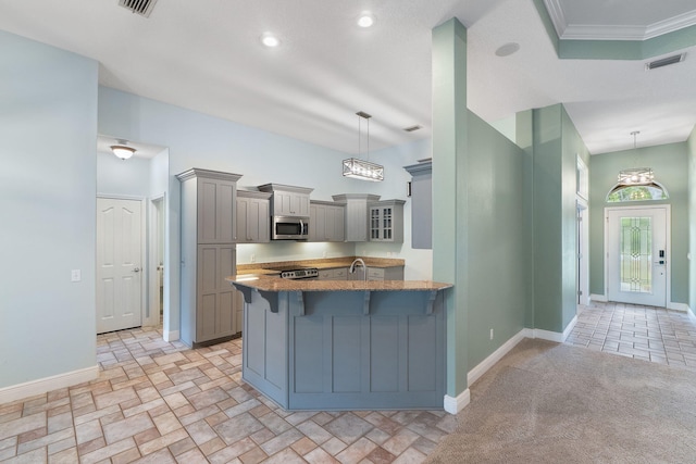 7008 Turnberry Cir, Navarre, FL 32566 - kitchen featuring stainless steel microwave, light stone countertops, a kitchen bar, gray cabinets, and a peninsula