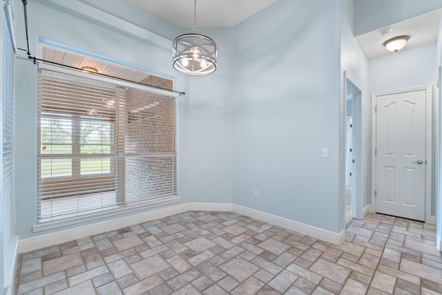 7008 Turnberry Cir, Navarre, FL 32566 - unfurnished dining area featuring a chandelier, brick floor, and baseboards