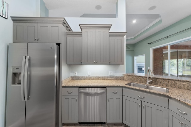 7008 Turnberry Cir, Navarre, FL 32566 - kitchen featuring appliances with stainless steel finishes, a sink, light stone countertops, and gray cabinets