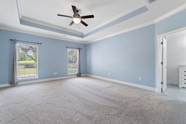 7008 Turnberry Cir, Navarre, FL 32566 - unfurnished room featuring a raised ceiling, crown molding, a ceiling fan, and light carpet