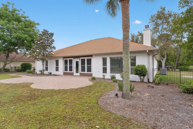 7008 Turnberry Cir, Navarre, FL 32566 - back of property with a patio, a yard, a chimney, brick siding, and fence