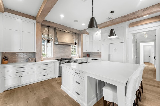 98 Compass Point Way, Inlet Beach, FL 32461 - kitchen with premium range hood, stainless steel range, a sink, beam ceiling, and backsplash