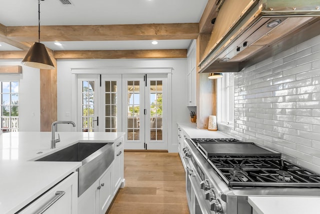 98 Compass Point Way, Inlet Beach, FL 32461 - kitchen with double oven range, under cabinet range hood, a sink, beam ceiling, and light countertops