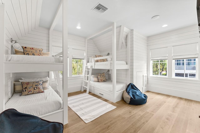 98 Compass Point Way, Inlet Beach, FL 32461 - bedroom featuring wood finished floors, vaulted ceiling, and wooden walls