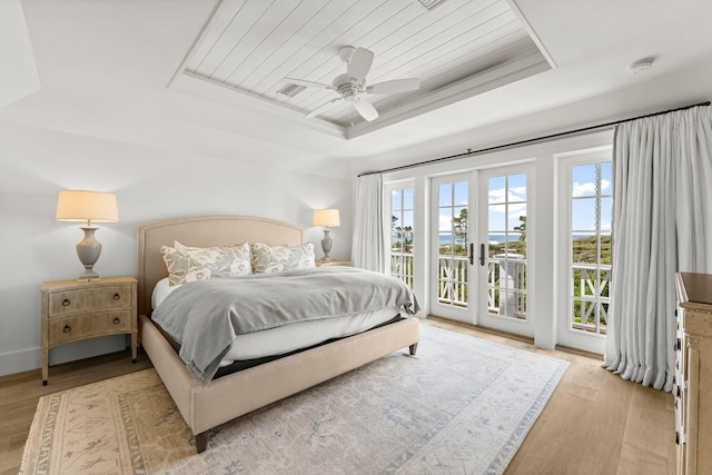98 Compass Point Way, Inlet Beach, FL 32461 - bedroom featuring a tray ceiling, access to exterior, light wood-style flooring, wooden ceiling, and a ceiling fan