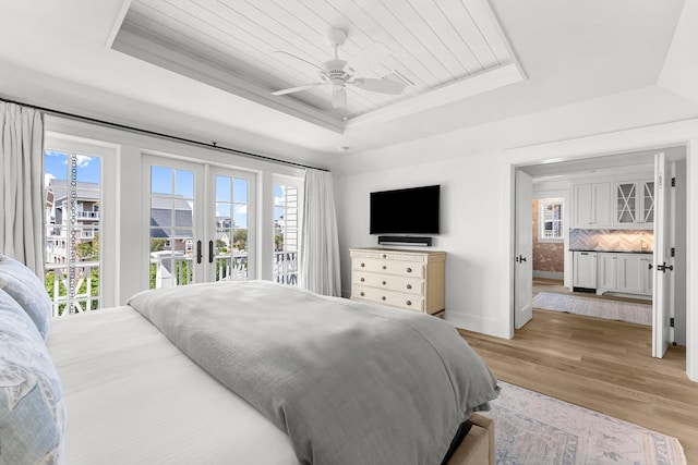 98 Compass Point Way, Inlet Beach, FL 32461 - bedroom with a tray ceiling, multiple windows, access to outside, and light wood finished floors