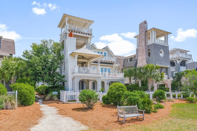 98 Compass Point Way, Inlet Beach, FL 32461 - view of front of home featuring a balcony, a chimney, ceiling fan, and a standing seam roof