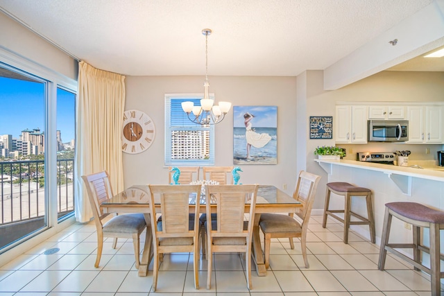 dining room with a healthy amount of sunlight, a view of city, light tile patterned flooring, and a notable chandelier