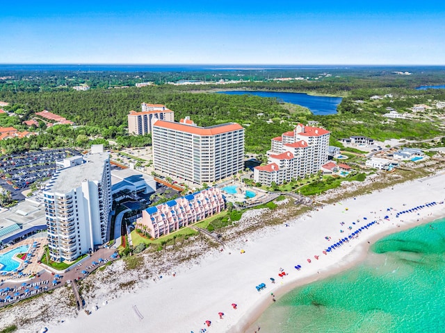 drone / aerial view with a beach view and a water view