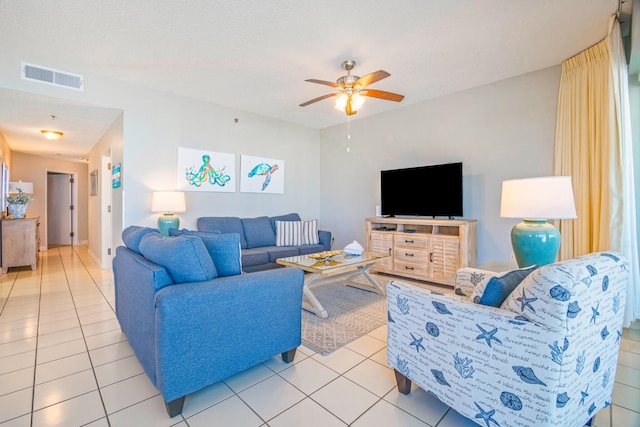 living room featuring visible vents, ceiling fan, and light tile patterned floors