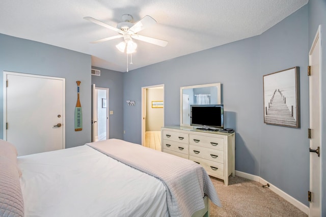 bedroom with baseboards, visible vents, ceiling fan, and light colored carpet