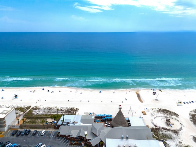 birds eye view of property featuring a view of the beach and a water view